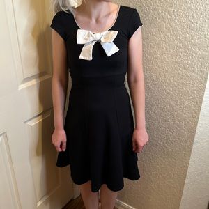 Black vintage style dress with white bow by Rock Steady from Unique Vintage.